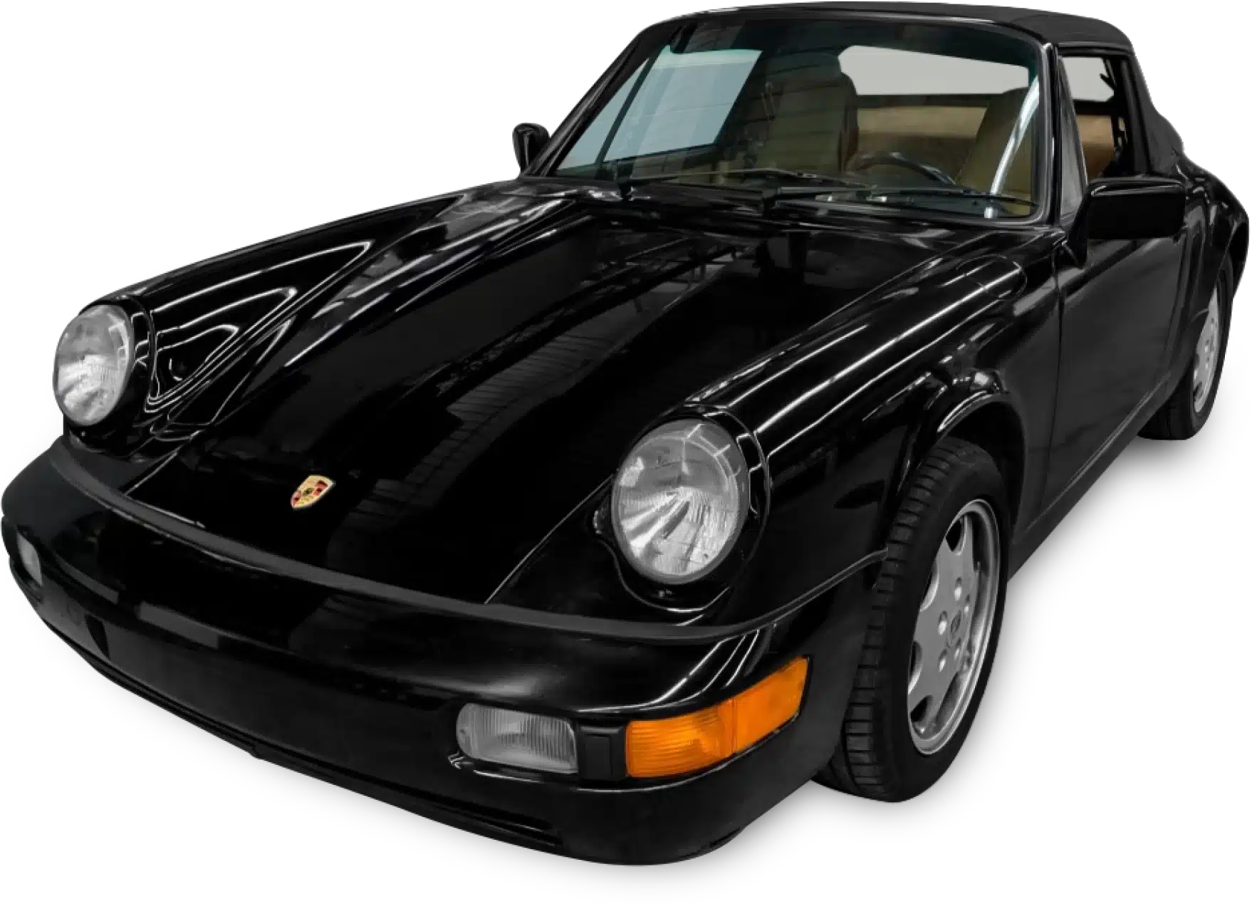 A sleek black Porsche 911 Carrera with a convertible top, viewed from the front-left angle.