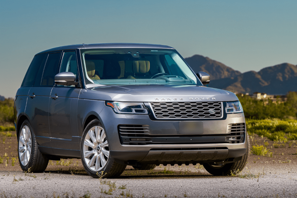 range rover repair, european auto repair in Milwaukee, WI at O'Reilly Motor Cars. A sleek gray Range Rover parked in a scenic outdoor setting with mountains in the background.