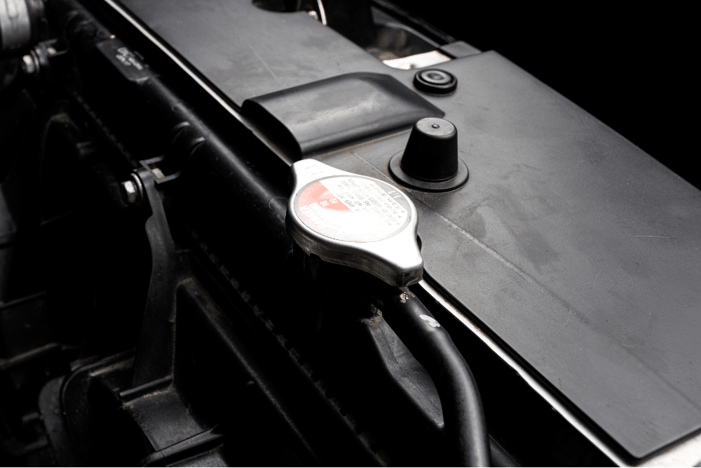 BMW cooling system, european auto repair in Milwaukee, WI at O'Reilly Motor Cars. Image showing a close-up of a vehicle radiator cap and cooling system components, emphasizing the importance of diagnostics and electrical repair for European and luxury vehicles.