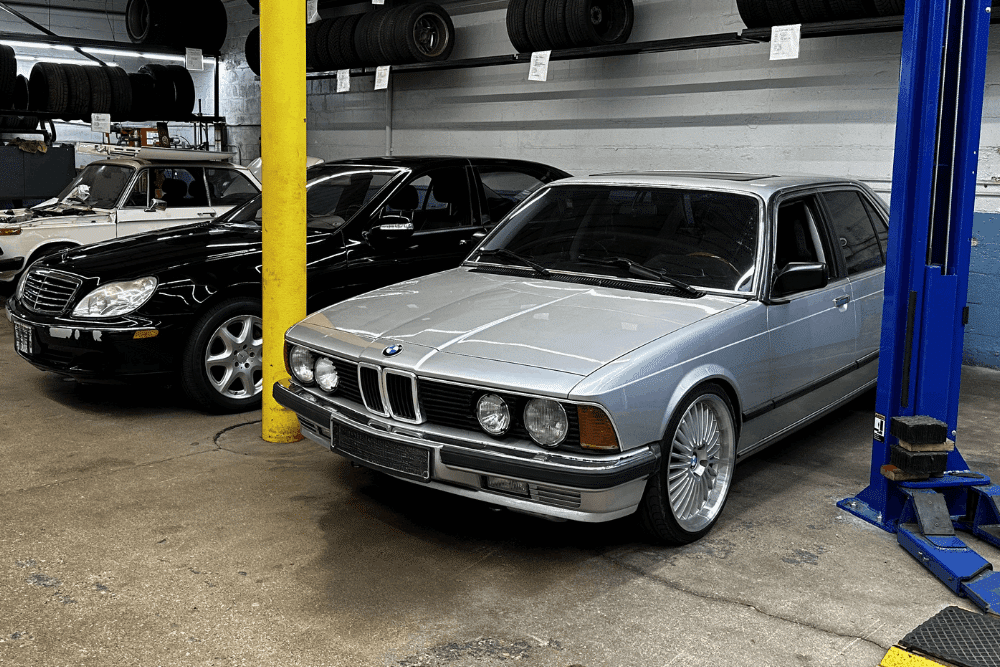 BMW and Mercedes service and repair in Milwaukee, WI by O'Reilly Motor Cars. Image of a classic BMW and Mercedes-Benz inside a professional auto repair shop, highlighting specialized service and maintenance for vintage and luxury European vehicles.