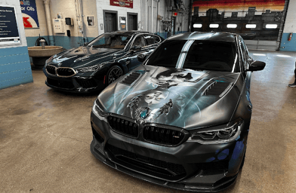 Causes of your BMW brake fluid leaks in Milwaukee, MI with O’Reilly’s Motor Cars. Image of 2 newer BMW model cars parked in the shop for brake repair services.