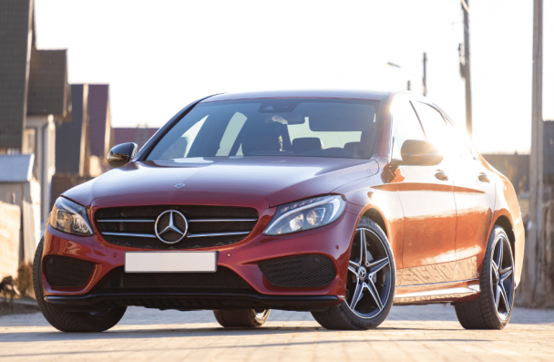 a/c european car, european auto repair in Milwaukee, WI at O'Reilly Motor Cars. Image of a red luxury sedan parked outdoors with sunlight highlighting the body.