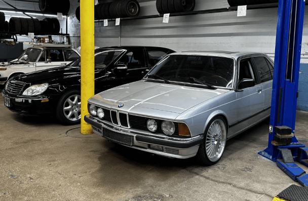 BMW and Mercedes service and repair in Milwaukee, WI by O'Reilly Motor Cars. Image of a classic BMW and Mercedes-Benz inside a professional auto repair shop, highlighting specialized service and maintenance for vintage and luxury European vehicles.