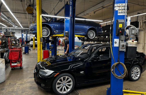 routine car maintenance, european auto repair in Milwaukee, WI at O'Reilly Motor Cars. Black and blue car inside an auto repair shop ready for maintenance check.